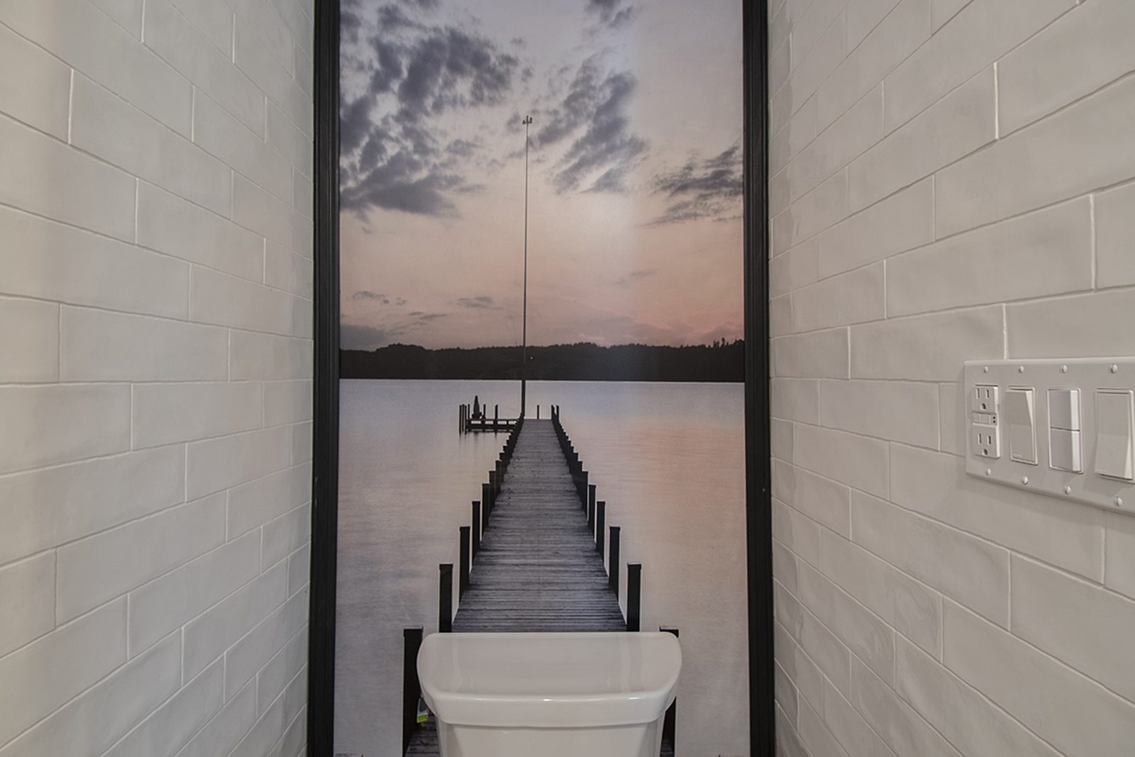 Unit C's tiled bathroom with a framed photographic mural running the height of the wall.