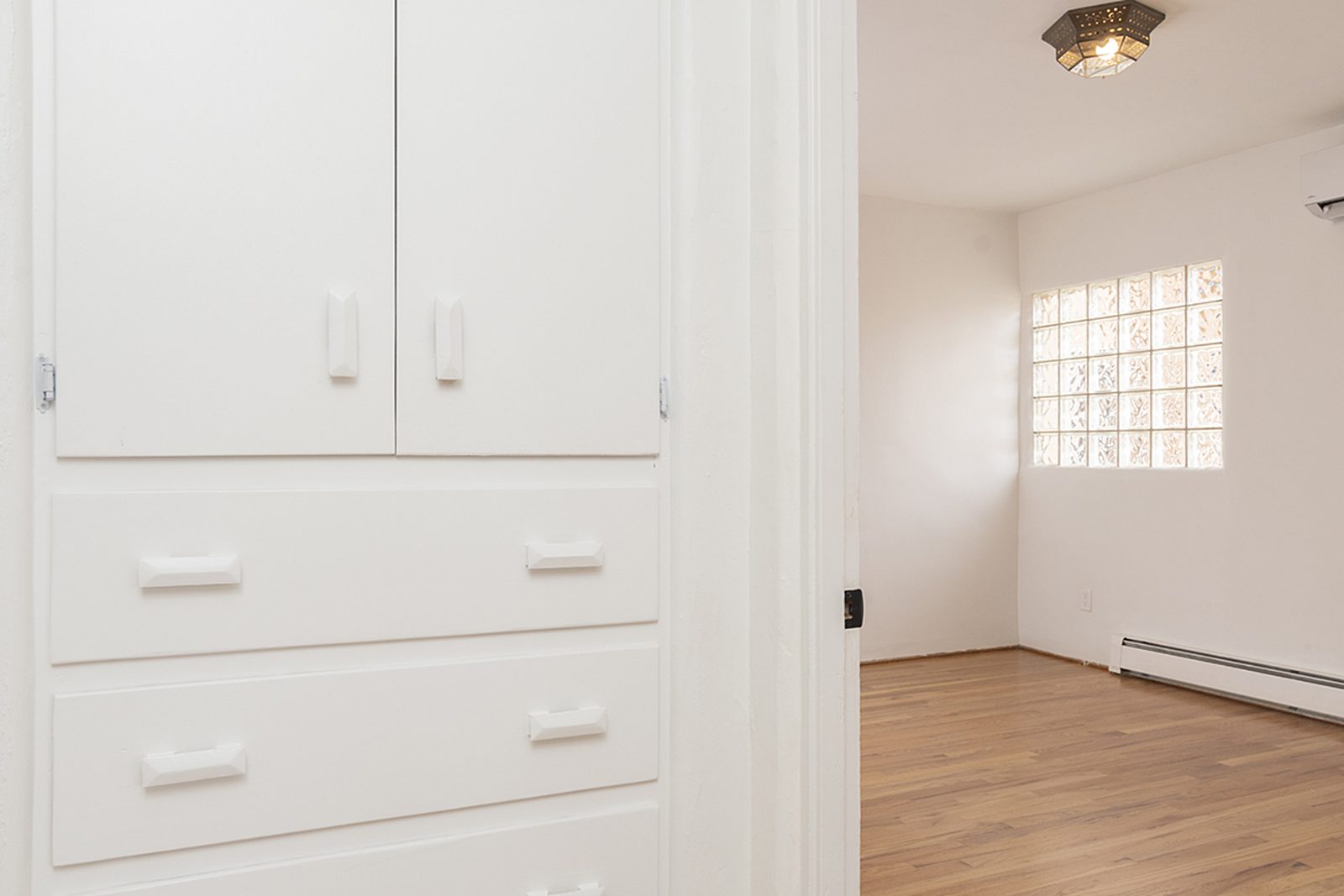 A full wall of built-in drawers and cabinets in Unit C's second bedroom.