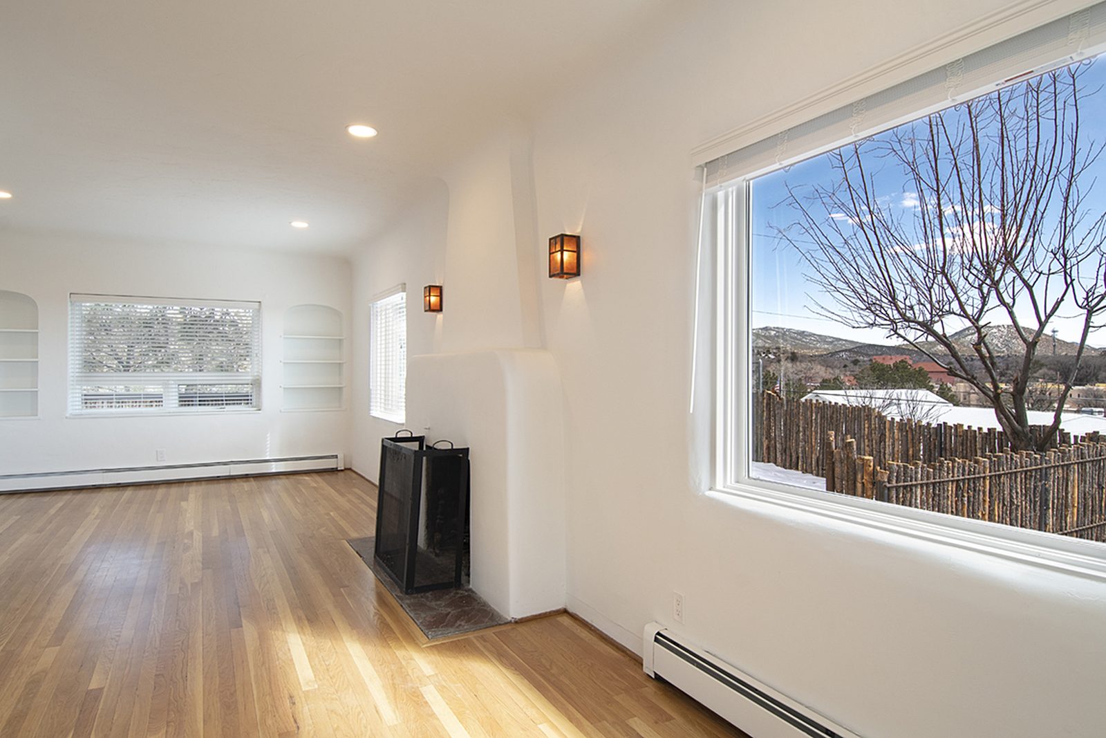 Another view of Unit C's great room, hardwood floors running to a large picture window with a mountain view.