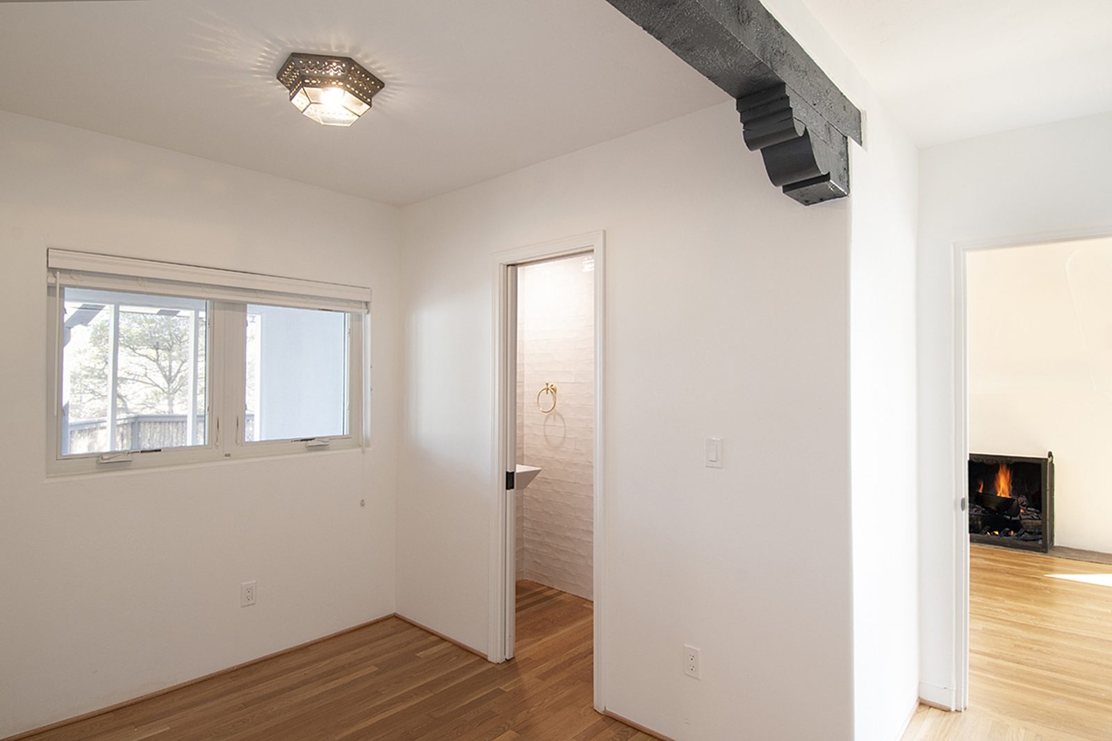 Unit C's office, a separate room with a window and a doorway through to the hall.