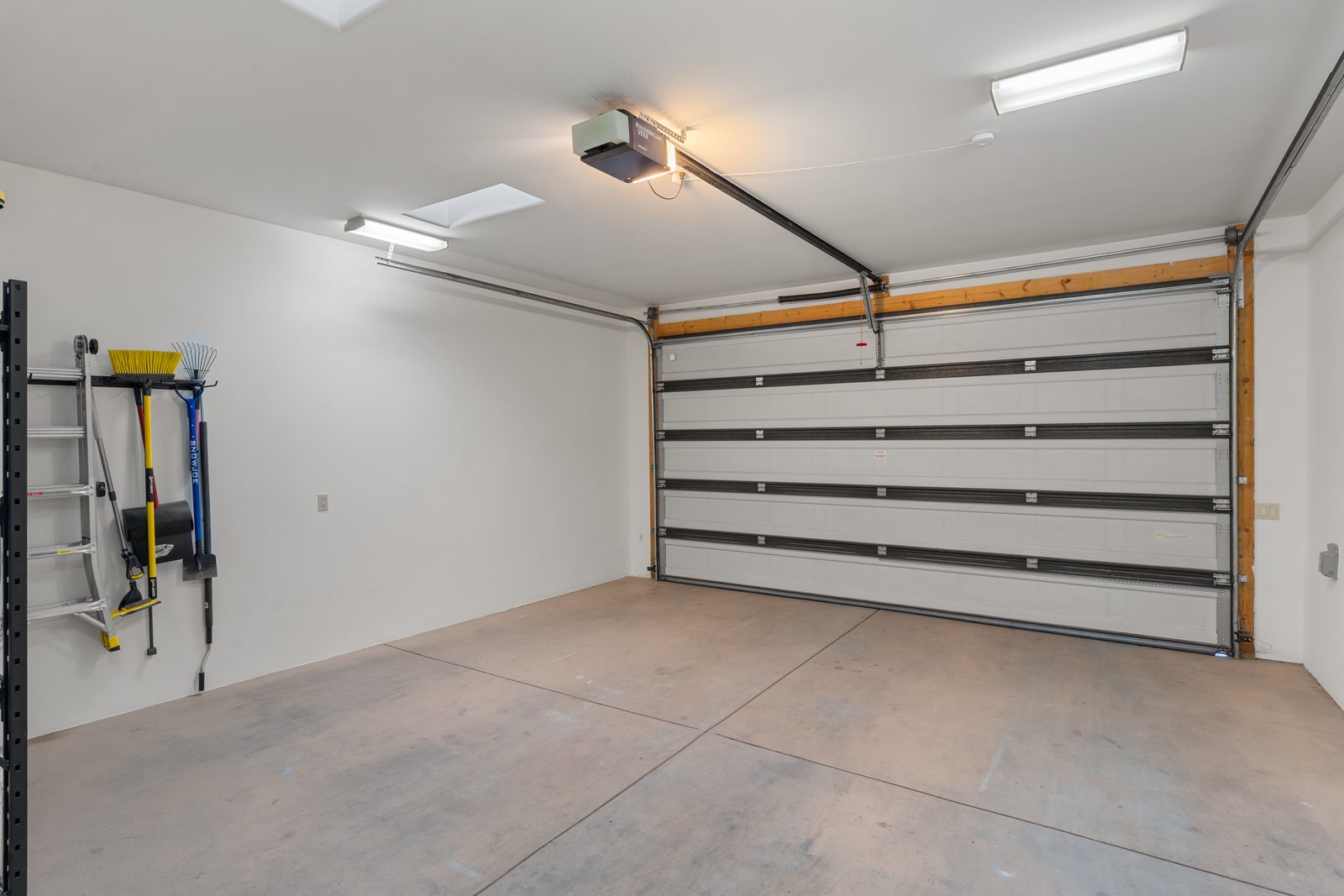 The casita's own two-car garage, clean and lit, with room for skis and bikes.